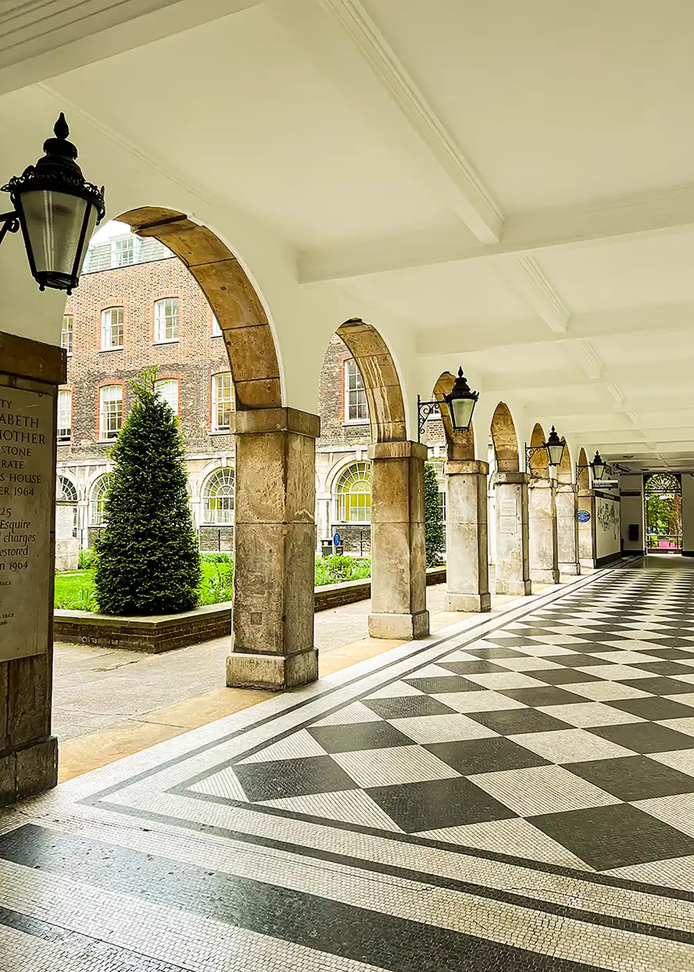 Side view of the King's College London arched and black and white tiled hall way - KCLSU 2023.