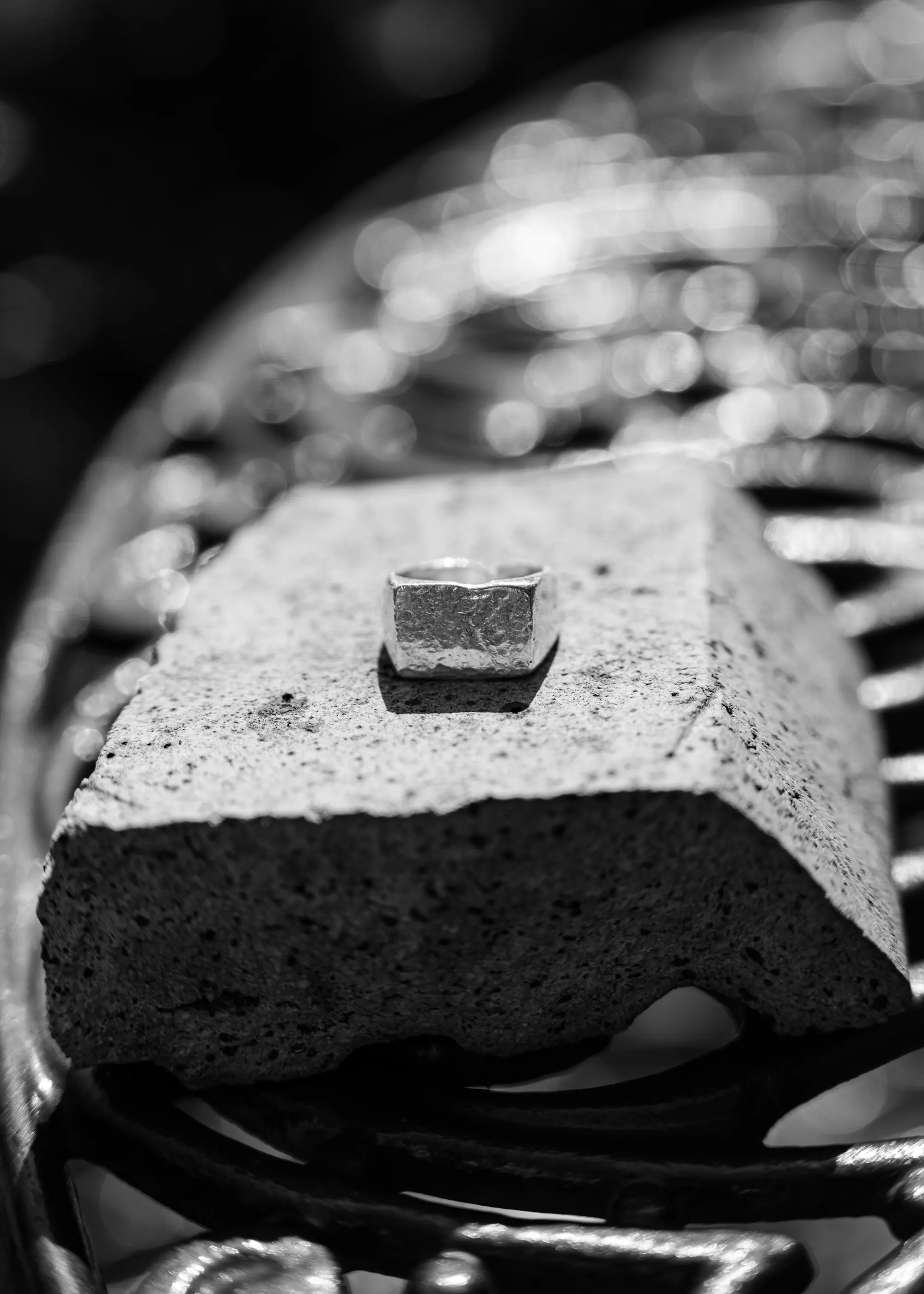 A silver square edged ring, placed on a rock - Silvawear.